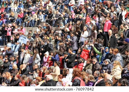 ISTANBUL - APRIL 23: Crowd of music fans cheer up during pop singer Bengu Erden performs live at Marmara Egitim Kurumlari on April 23, 2011 in Istanbul, Turkey.