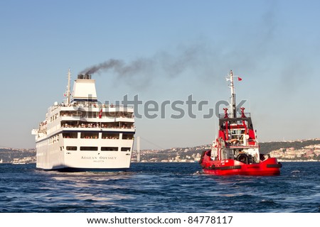 ISTANBUL - AUGUST 22:Luxury cruise ship Aegean Odyssey sails into open sea after a short visit in Istanbul port on August 22, 2011 in Istanbul.Pilot boats always monitor cruise ships in Bosporus Sea