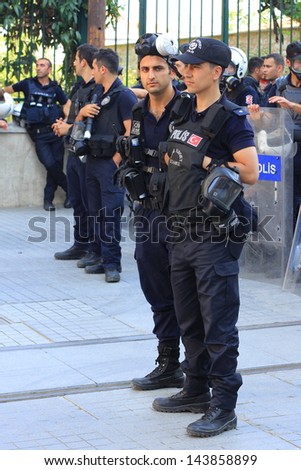 ISTANBUL - JUN 17: Five labor unions call 1-day nationwide strike over crackdown on June 17, 2013 in Istanbul, Turkey. Police wearing full equipment belt wait against demonstrators on Istiklal Street
