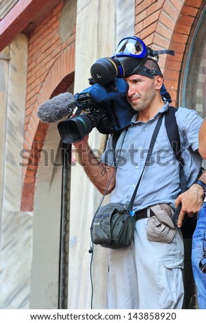 ISTANBUL - JUN 17: Five labor unions call 1-day nationwide strike over crackdown on June 17, 2013 in Istanbul, Turkey. A local cameraman recording the demonstration at Istiklal Street