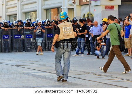 ISTANBUL - JUN 17: Five labor unions call 1-day nationwide strike over crackdown on June 17, 2013 in Istanbul, Turkey. SIPA Press Agency photographer between demonstrators and police line