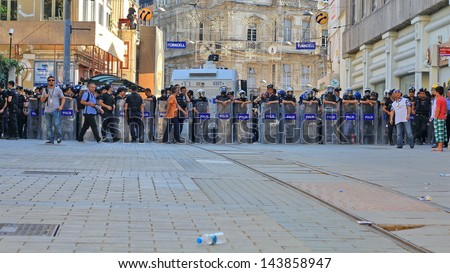 ISTANBUL - JUN 17: Five labor unions call 1-day nationwide strike over crackdown on June 17, 2013 in Istanbul, Turkey. Police lined up against demonstrators during the protest on Istiklal Street.