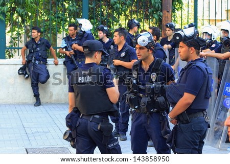 ISTANBUL - JUN 17: Five labor unions call 1-day nationwide strike over crackdown on June 17, 2013 in Istanbul, Turkey. Police wearing full equipment belt wait against demonstrators on Istiklal Street
