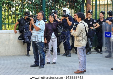 ISTANBUL - JUN 17: Five labor unions call 1-day nationwide strike over crackdown on June 17, 2013 in Istanbul, Turkey. International journalists report live in front of police line at Istiklal Street