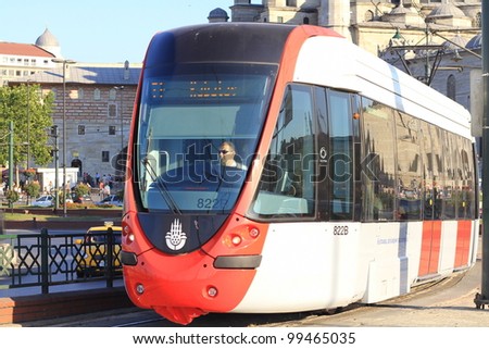 ISTANBUL - JULY 22: A modern tram on Galata Bridge on July 22, 2011 in Istanbul. Due to increasing traffic & air pollution, Istanbul became one of most polluted city also planned for return of tram.