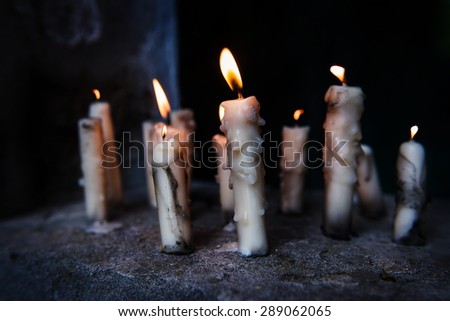 candles in the wind in the tomb in the cemetery at night