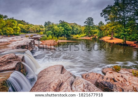 Similar – Image, Stock Photo Thunderstorm over the hill . Only a small bright glow over the blue black rain clouds, the rainforest.  As if the world wanted to end.