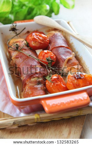 salmon wrapped in prosciutto di parma with gorgonzola cheese and tomatoes