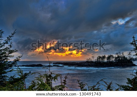 Rough ocean with storm clouds from golden sunset above