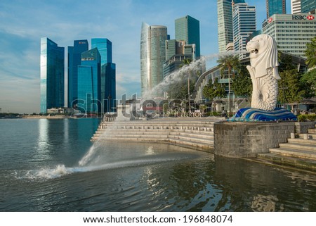 SINGAPORE - May 10: The Merlion fountain in front of the Marina Bay Sands hotel on May 10, 2014 in Singapore. Merlion is a imaginary creature with the head of a lion, seen as a symbol of Singapore