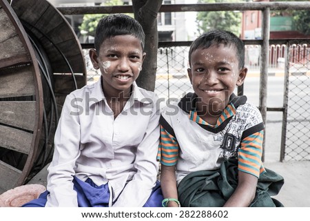 Bagan, Myanmar - OCTOBER 20: Children make money selling bird food with a smile in Bagan, Myanmar on October 20, 2014. Currently, 26% of Burma\'s population lives below the poverty line.