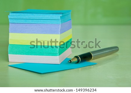 Block of colorful Post it Notes with pen