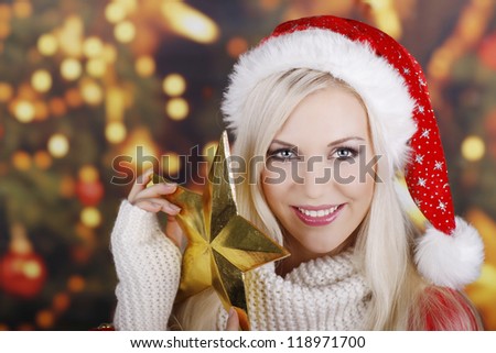 Smiling woman in santa costume with a golden star