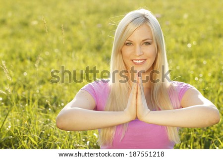 Relaxed woman doing yoga outdoor