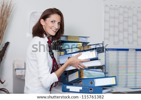 Young businesswoman stacks files on a table in the office