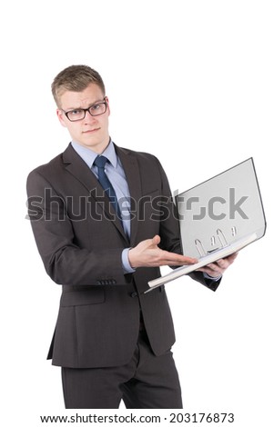 Cut out image of a young dissatisfied businessman with glasses who is pointing to an opened file with his hand. The man is looking to the camera.