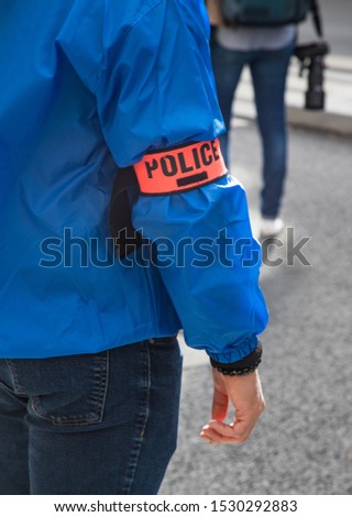 Close up on French police officer wearing police identification armband on the streets of Paris ストックフォト © 