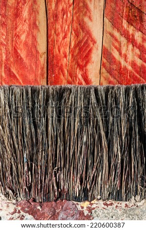 closeup paint brush bristles on grunge wood texture