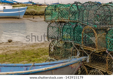 Lobster pots with boats on a sea inlet