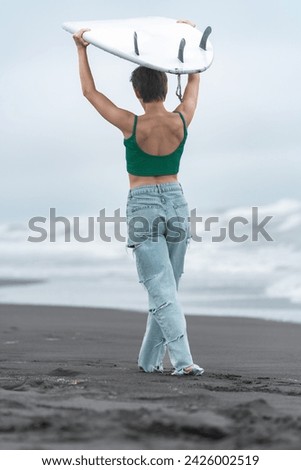 Similar – Image, Stock Photo Anonymous female surfer walking on beach with surfboard