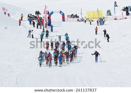 AVACHA VOLCANO, KAMCHATKA, RUSSIA - APRIL 26, 2014: Mass start race, ski mountaineers climb to mountain on skis. Individual race ski mountaineering Asian, ISMF, Russian and Kamchatka Championship.