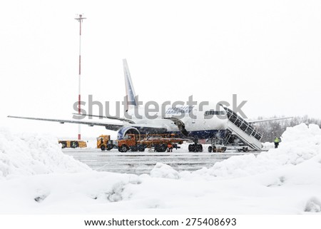 KAMCHATKA, RUSSIA - MARCH 19, 2015: Technical and service support airfield maintenance airplane Boeing-767 Transaero Airlines at airport of Petropavlovsk City during a snowfall and poor visibility.