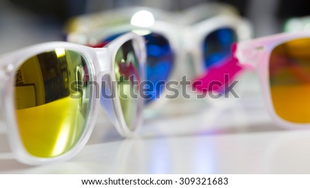 Many colorful reflected mirror bright sunglasses close up