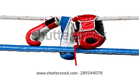 Boxing gloves and headguard hang on boxing ring rope.White isolate background.