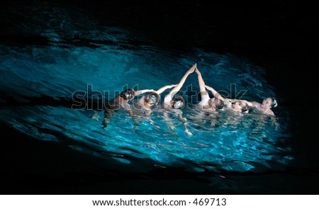 Swimming team creating a shape with arms