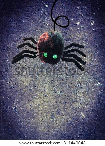 black spider monster on concrete wall background for concept of halloween