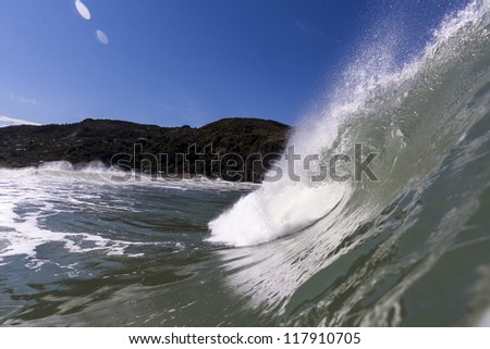 Wave Tubing/ an excellent left hand breaking and peeling wave barrels at Piha Beach, New Zealand