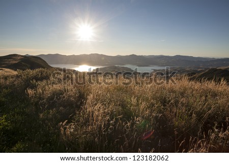 Banks Peninsula/Overlooking Akaroa Harbour with the sun in the western sky