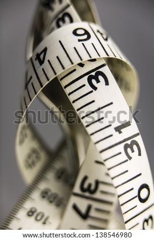 Measure Tape on Fork/a tape measure wrapped around a fork