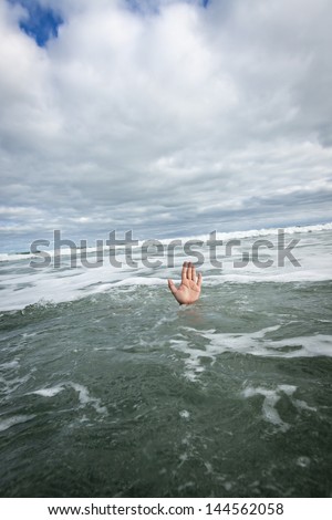 drowning swimmer/ a hand reaching and signalling for help
