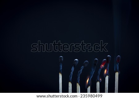 Matchsticks burning/ a row of lined up matches just at the end of burning