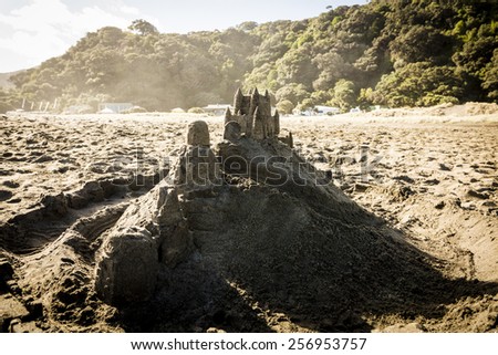Sand Castle/ a large sand castle made in iron rich sand on Piha Beach, New Zealand