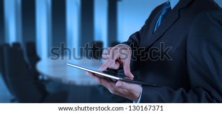 businessman success working with tablet computer his board room background