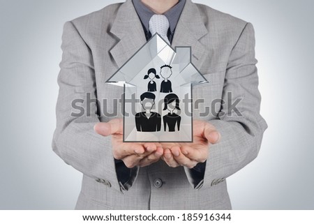 businessman holding hand drawn family icon and 3d house as insurance concept