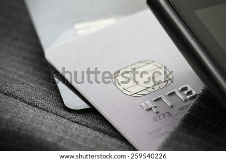 Credit cards in very shallow focus  with gray suit background
