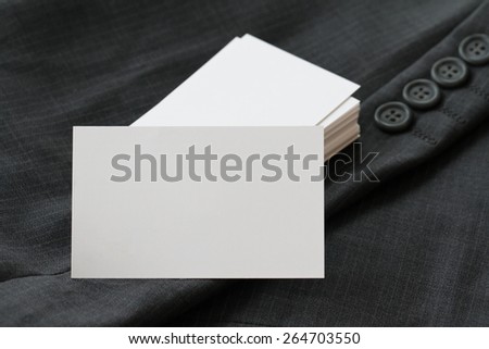 Blank corporate identity package business card with dark grey suit  background.