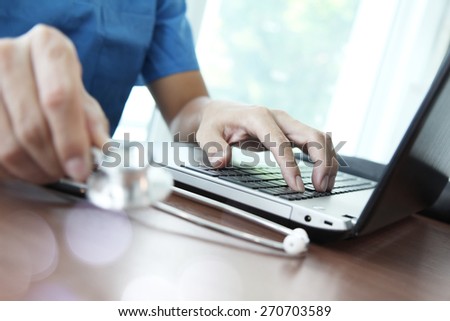 Doctor working with laptop computer in medical workspace office as concept