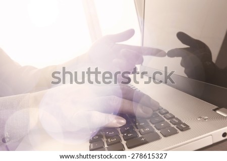Close up of business man hand working on laptop computer with social media diagram and chart graph on wooden desk as concept
