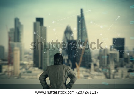 businessman stands successfully on building top Looking Towards the future with social media diagram