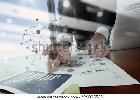 Double exposure of business man hand working on blank screen laptop computer on wooden desk as concept with network diagram