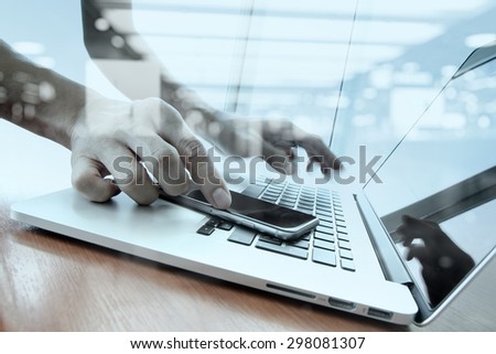double exposure of moving businessman hand working with smart phone with laptop computer