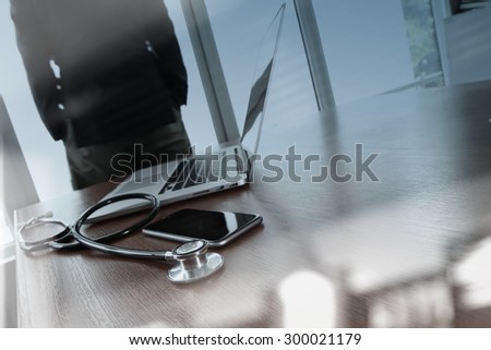 Doctor working with digital tablet and laptop computer in medical workspace office and medical network media diagram as concept