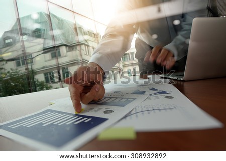 Double exposure of business man hand working on blank screen laptop computer on wooden desk as concept