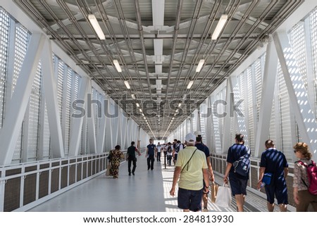 MILAN, ITALY - JUNE 3, 2015 - Expo Milano 2015, Students and visitors walking on flyover to exhibition site
