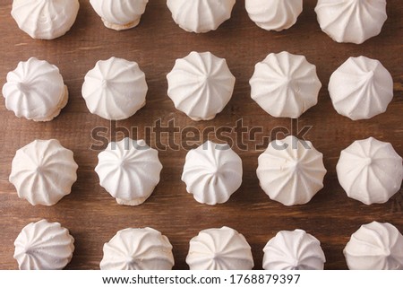 sigh or homemade meringue is a sweet made from egg whites, sugar and lemon on the rustic kitchen wooden table. Selective Focus Foto d'archivio © 