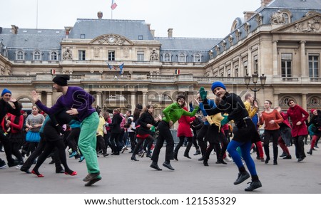 PARIS - DECEMBER 9: People dance at Palais Royal square on December 9, 2012 in Paris, France. This flash mob is held in memory of famous dancer Dominique Bagouet.